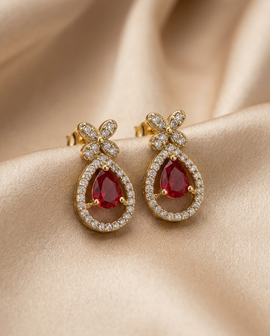 Earrings placed on champagne satin cloth for a premium look