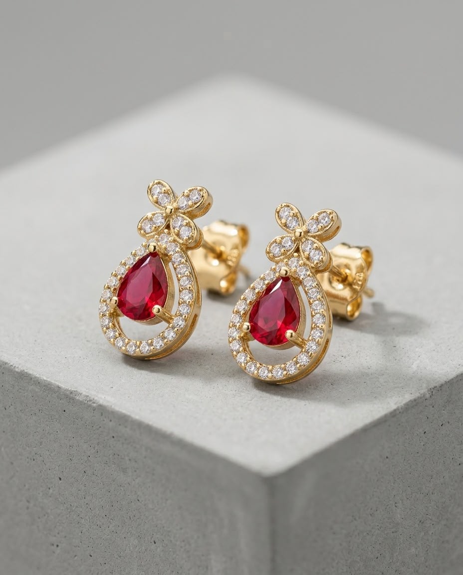 Earrings photographed on a concrete studio prop
