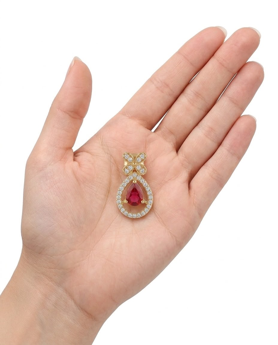 Earring held in a hand to show scale